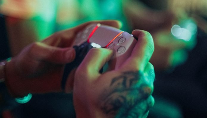 Person playing on PS5 controller