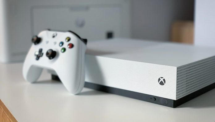 white xbox one s console on white table